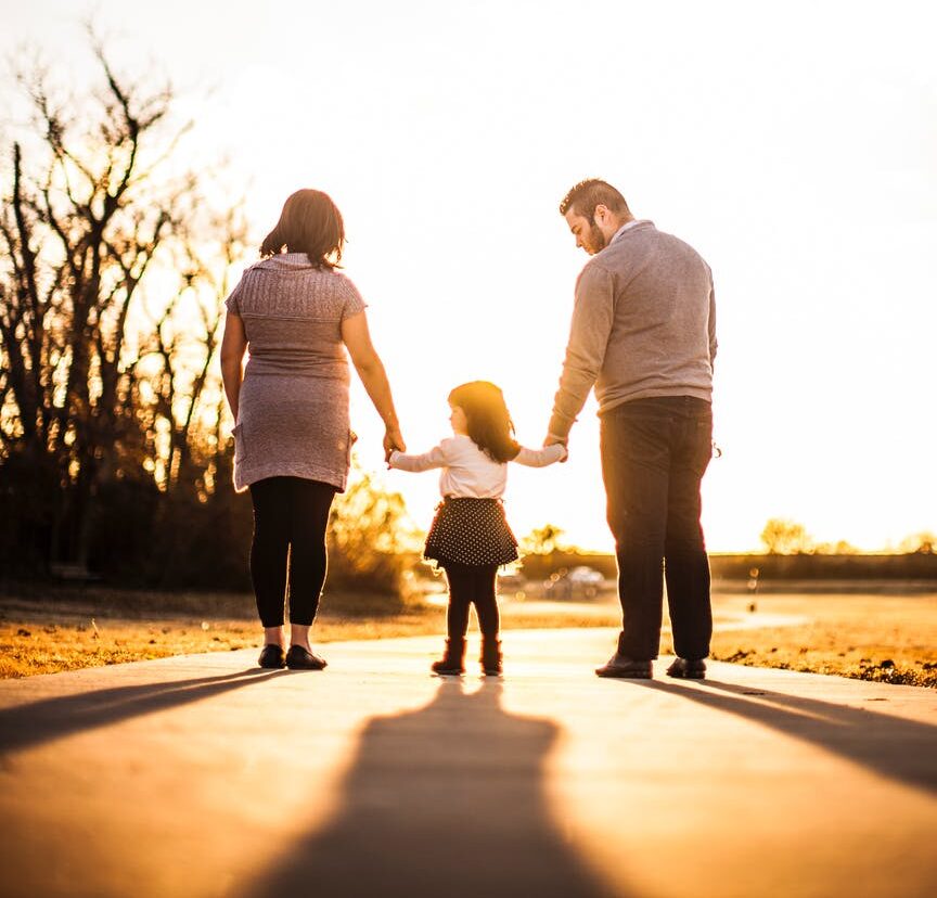 photo of family standing outdoors during golden hour